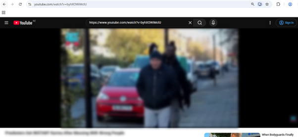 A YouTube video player fully blurred, with the page's address bar showing the video URL